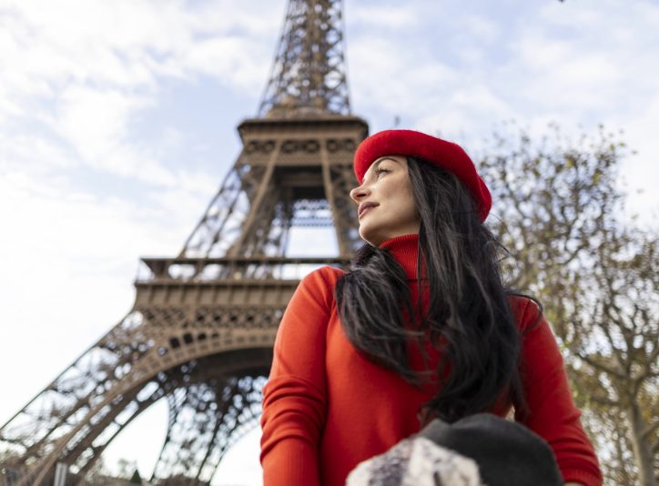 a-stylish-woman-in-a-red-beret-poses-near-the-eiff-2024-10-04-21-13-15-utc