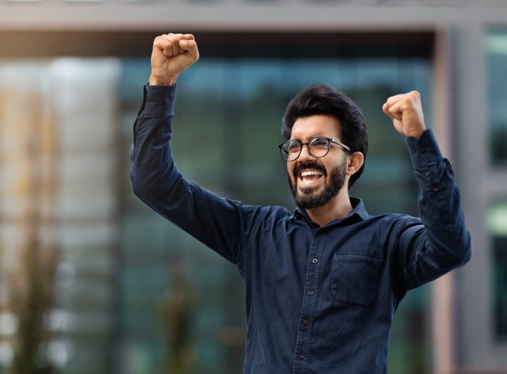 excited-happy-young-eastern-man-raising-hands-up-a-2023-11-27-04-51-05-utc