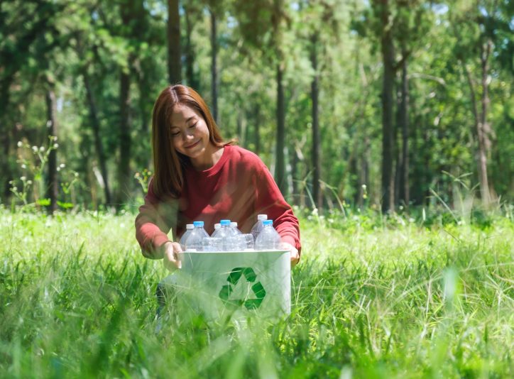 woman-collecting-garbage-plastic-bottles-into-a-re-2024-11-28-22-57-24-utc