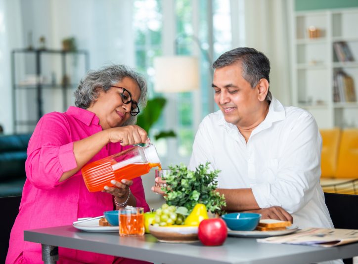 senior-woman-pouring-juice-for-man-at-table-2026-01-07-00-49-01-utc.jpg