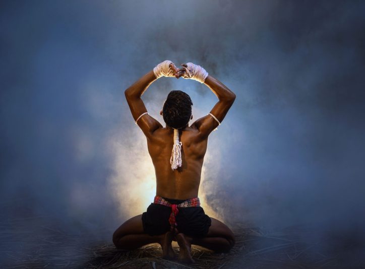 muscular-man-with-wrapped-hands-kneeling-in-fog-2026-03-26-11-58-16-utc