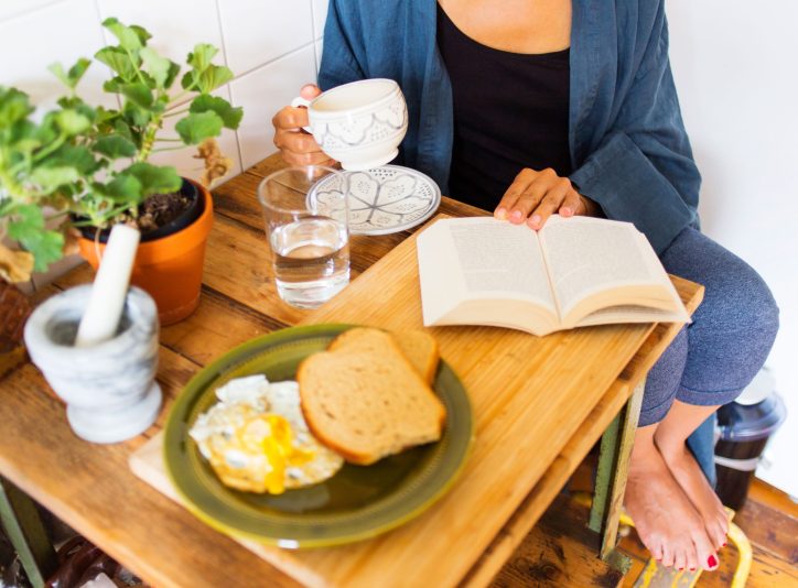 woman-enjoys-breakfast-and-reading-at-home-2026-03-09-22-25-29-utc woman-enjoys-breakfast-and-reading-at-home-2026-03-09-22-25-29-utc